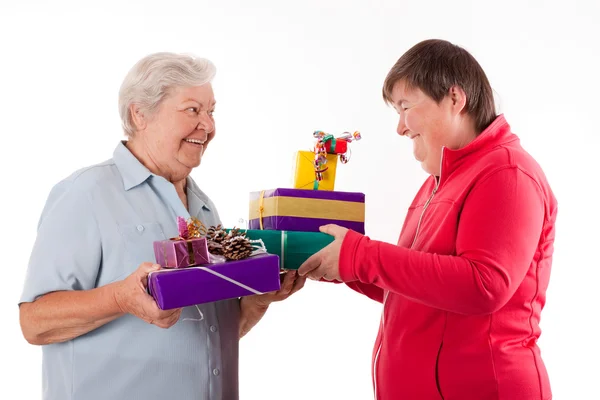 Senior and mental disabled woman holding gifts — Photo