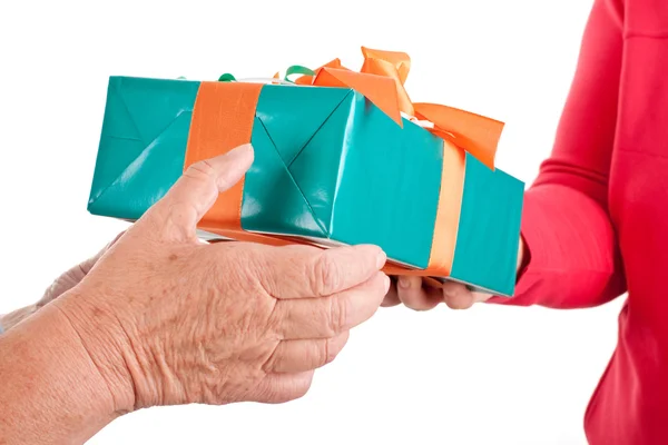 Closeup, hands reaching each other a gift — Stock Photo, Image