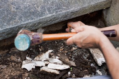 A craftsman pointed away old mortar