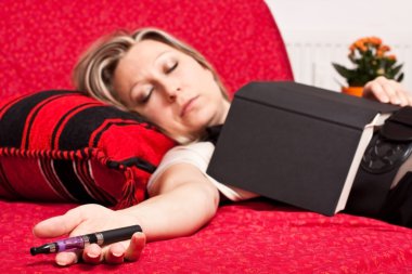 Blond woman asleep with E-Cigarette