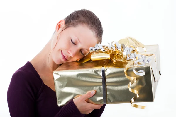 Attractive woman with golden package — Foto Stock