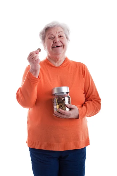 Senior holding a coin and a savings box — Zdjęcie stockowe