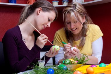 two beautiful women painted Easter eggs