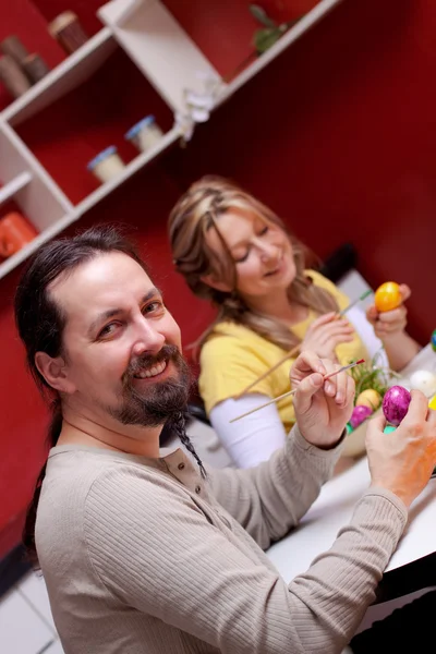 Couple is painting easter eggs — стоковое фото