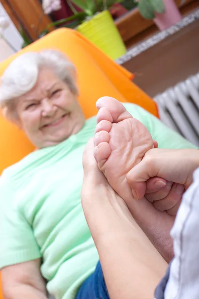 Female Nurse massaging foot of a patient — Photo