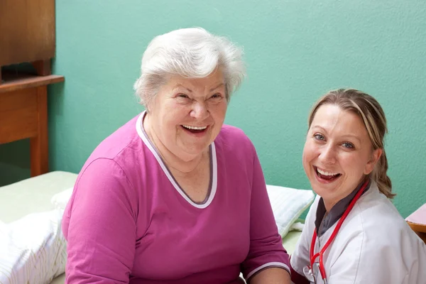 Senior and doctor are smiling — Zdjęcie stockowe