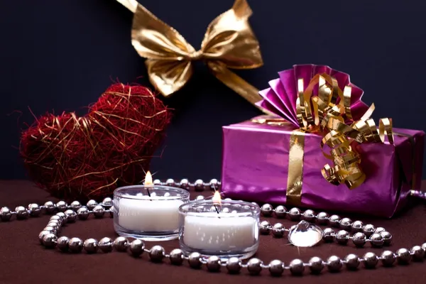 Festive background with gift and candles — Stock Photo, Image