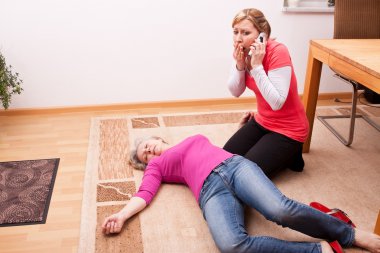 Senior collapsed young woman calling help