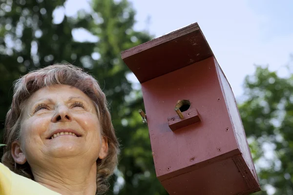 Woman pleased with birdhouses — Stock Photo, Image