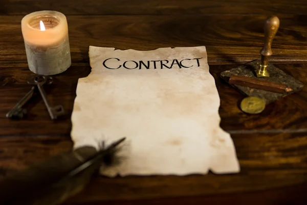 Old parchment with the word Contract — Stockfoto