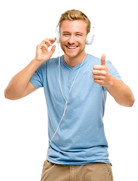 Jovem atraente usando fones de ouvido no fundo branco — Fotografia de Stock