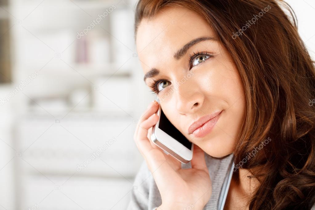 Pretty young woman using mobile phone