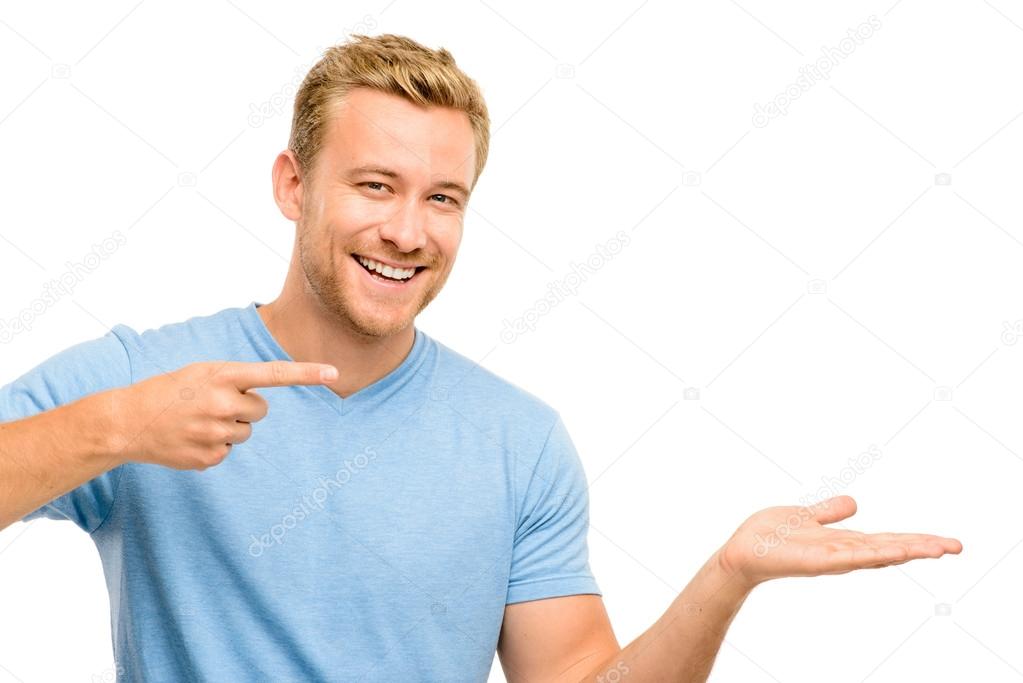 Happy young man showing empty copyspace on white background