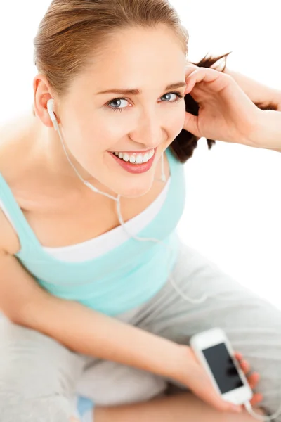 Portrait of attractive young woman listening to music at gym — Stock Photo, Image