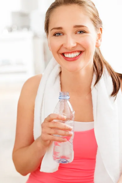 Portrait of attractive young woman drinking water at gym Royalty Free Stock Images