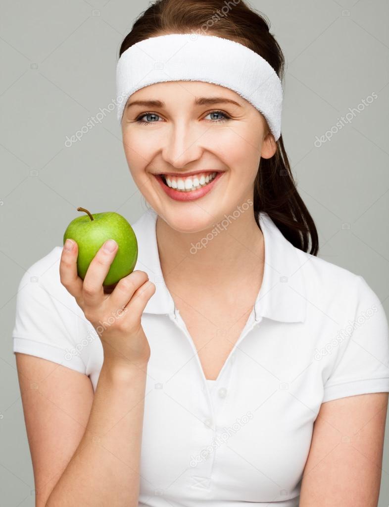 Young woman holding green apple