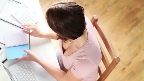 Pretty young student studying at desk at home — Stock Video