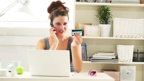 Pretty young woman shopping online by computer using her credit card — Stock Video