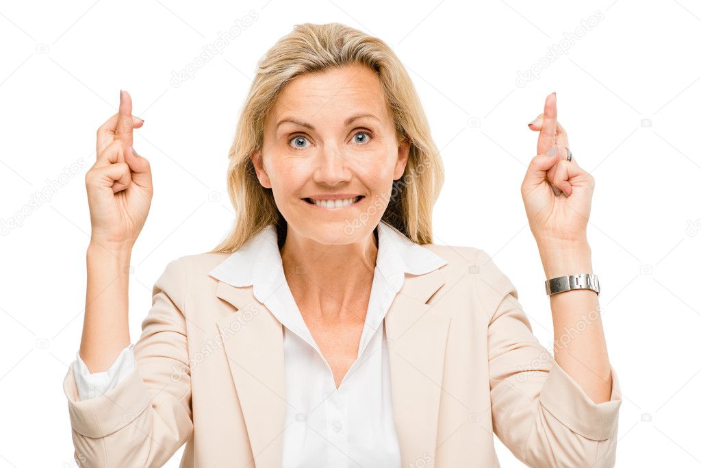 Mature business woman holding fingers crossed isolated on white