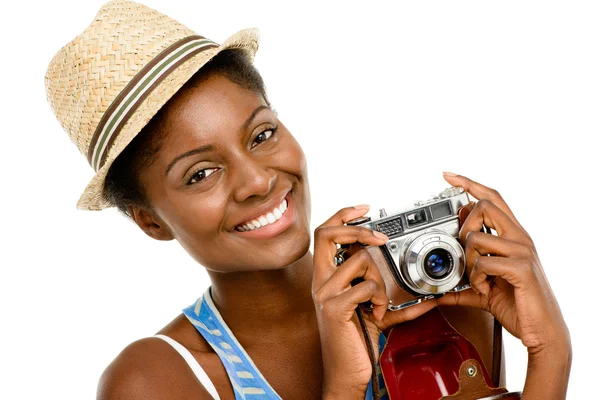 Happy African American woman tourist holding vintage camera isolated on white background — Stock Photo, Image