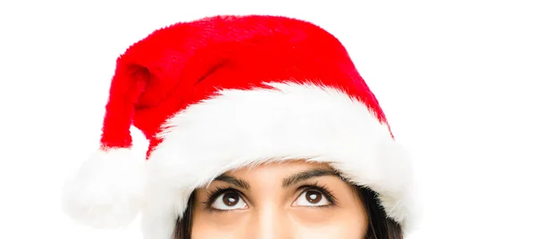 Close up of pretty woman wearing christmas hat looking up isolat — Stock Photo, Image