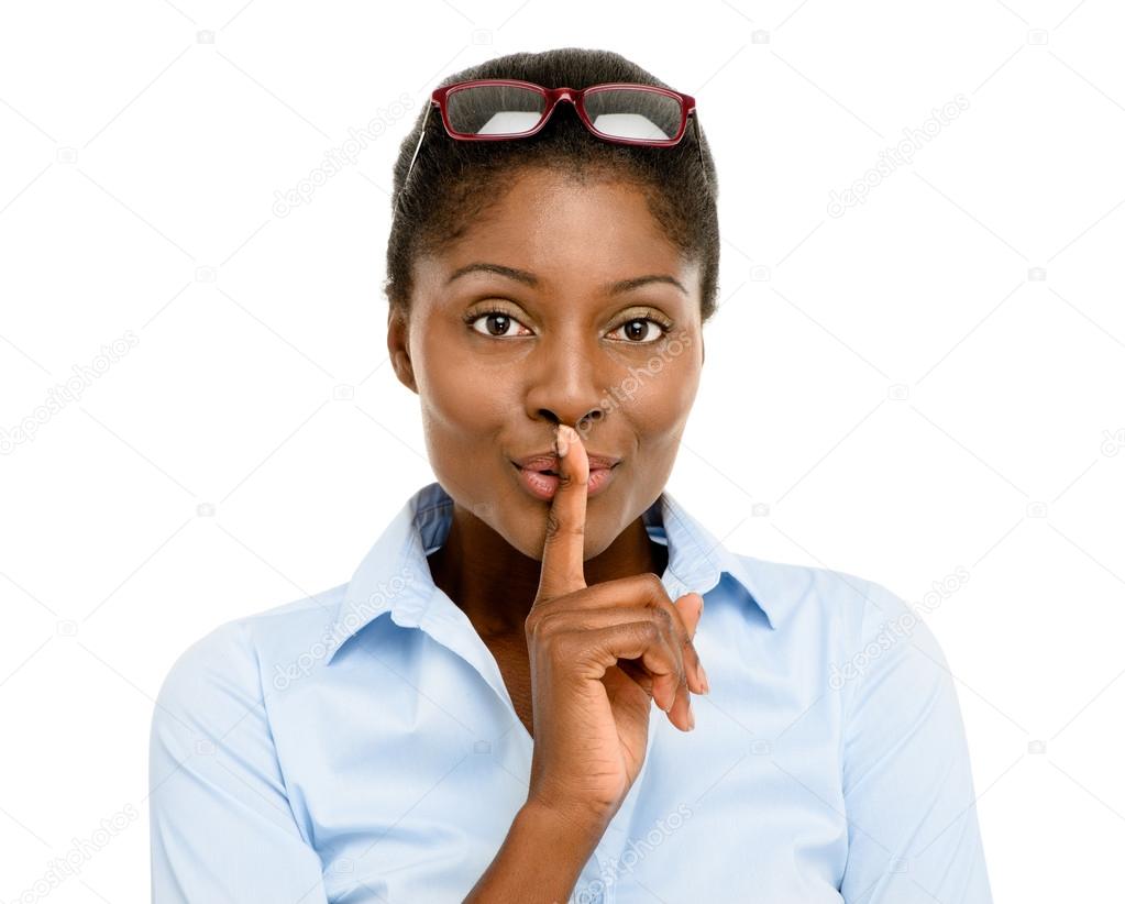 Happy African American business woman finger on lips isolated on