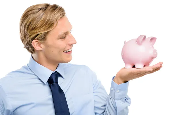 Confident young businessman holding piggybank — Stock Photo, Image