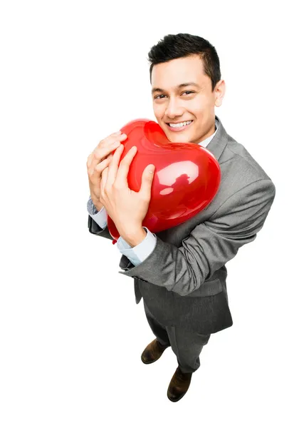 Businessman holding red heart balloon — Stock Photo, Image