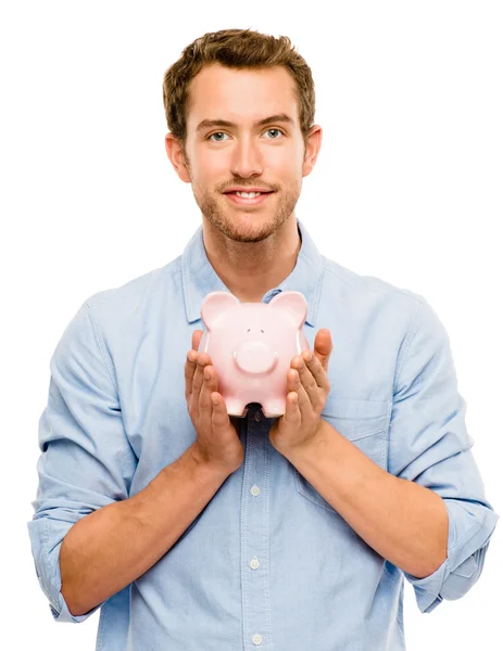 Happy young man putting money in piggy bank isolated on white — Stock Photo, Image