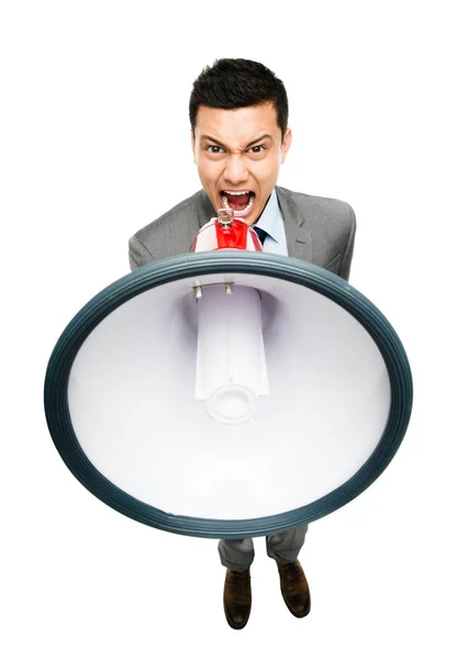 Fou asiatique businessman hurler dans mégaphone Image En Vente