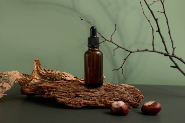 Kahverengi cam kozmetik ürünü şişesi ya da ahşap üzerinde yağ ve yeşil arka planda kağıt. Natura Spa Güzellik Konsepti, ekoloji ve doğal güzellik 