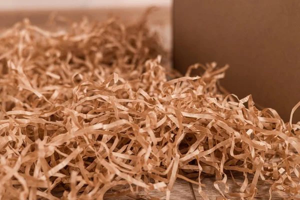 Moving day, box with paper material.Eco material for packaging goods, things, fragile items. Decorative wood shavings — 图库照片