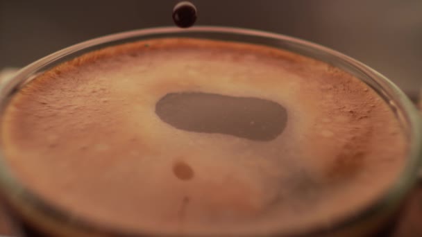 Espresso coffee drop into the filled Cup from the coffee machine in slow motion 4k macro view — Vídeo de Stock