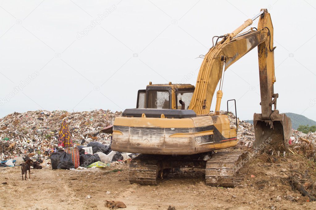 Tractor working the landfill Stock Photo by ©chayathon 32449735
