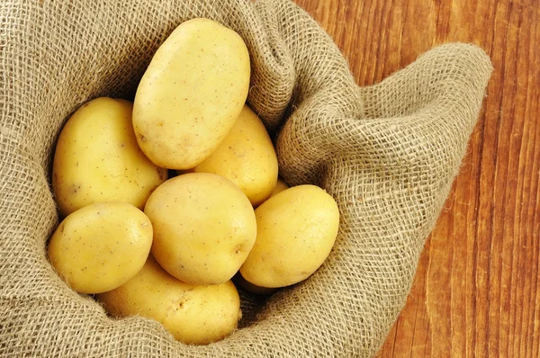 Surowe ziemniaki juta worek — Zdjęcie stockowe