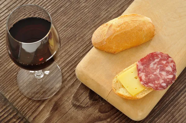Italian snack with bread, salami, cheese and red wine