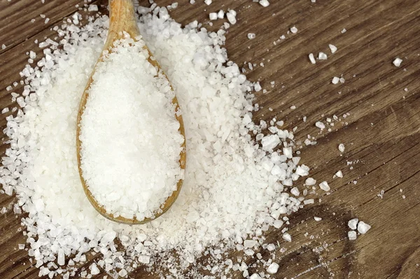 Coarse sea salt on a wooden spoon — Stock Photo, Image