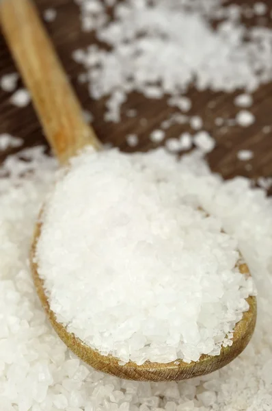 Coarse sea salt on a wooden spoon — Stock Photo, Image