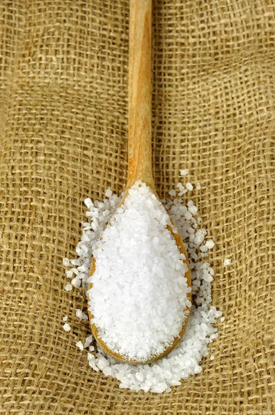 Coarse sea salt on a wooden spoon — Stock Photo, Image