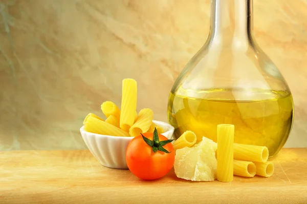 Raw tortiglioni pasta with parmesan, cherry tomato and olive oil — Stock Photo, Image