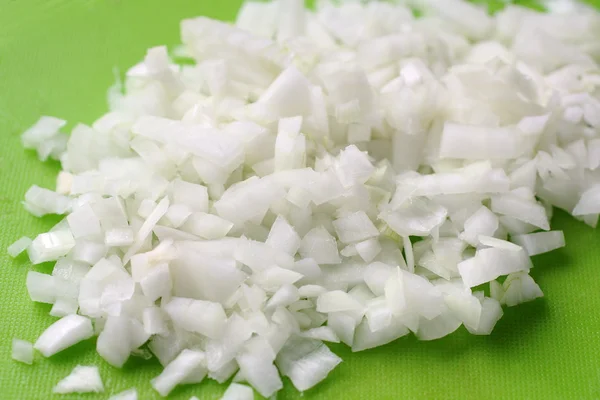 Fresh cut onion on green board — Stock Photo, Image