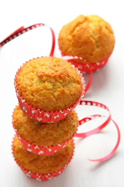 Muffins in red cups on white — Stock Photo, Image