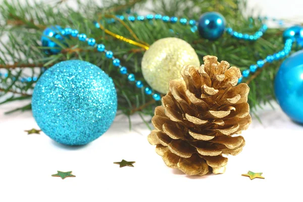 Christmas composition with pinecone and blue ball over white — Stock Photo, Image