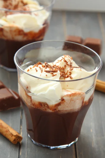 Fresh chocolate milkshake with cream on wooden table — Stock Photo, Image