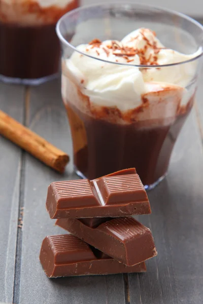 Chocolate pieces with chocolate milkshake and cinnamon stick — Stock Photo, Image