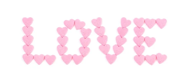 Ordet "kärlek" skrivet med små godis hjärtan — Stockfoto