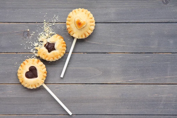 Homemade shortbread cookies on a stick on wooden background — Stock Photo, Image