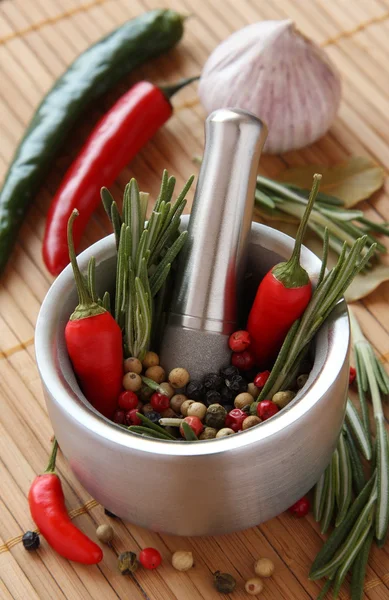 Erva de alecrim fresca e pimenta vermelha em argamassa metálica com pilão — Fotografia de Stock