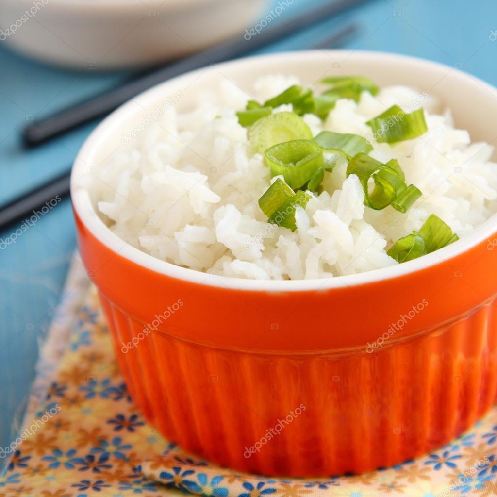 Bowl of cooked rice with green onion