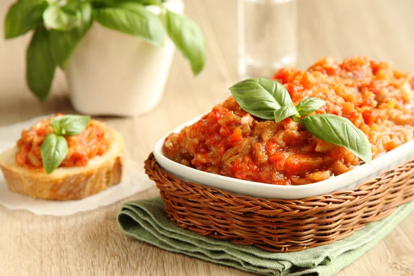 Eggplant salad (caviar) in bowl with basil leaves — Stock Photo, Image